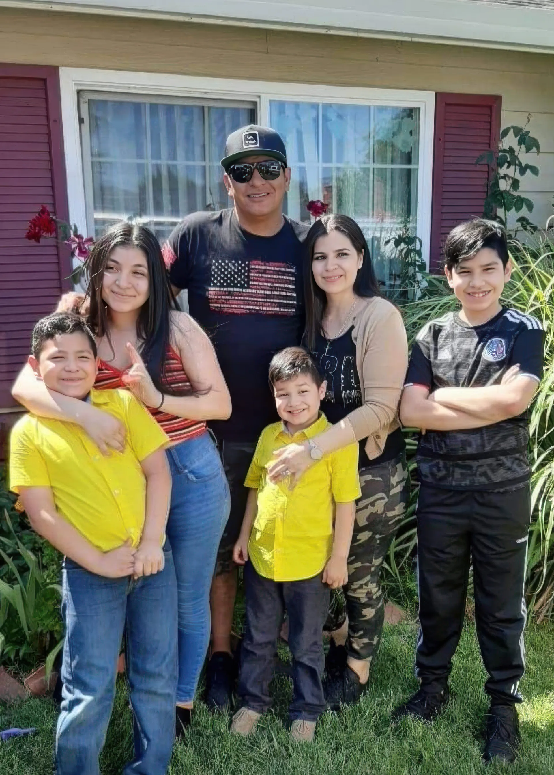 Happy family in front of their new roof